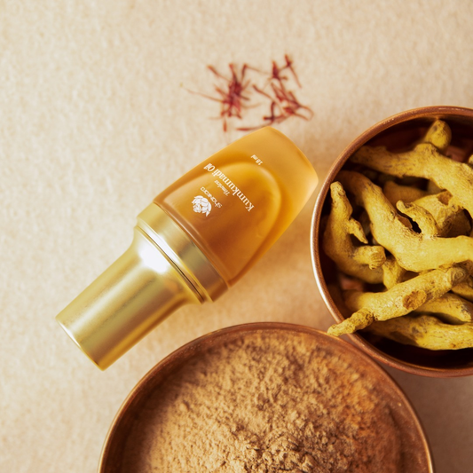 shankara kumkumadi oil bottle next to ayurvedic herbs.