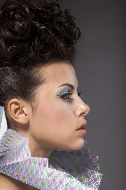 Side portrait of a woman with hair tied up in a bun.