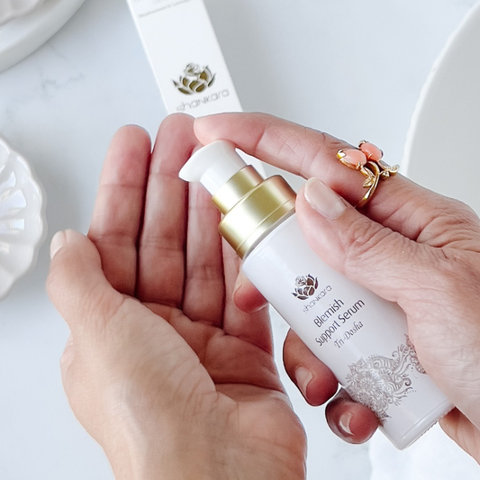 Shankara blemish support serum bottle held in a woman's hands.