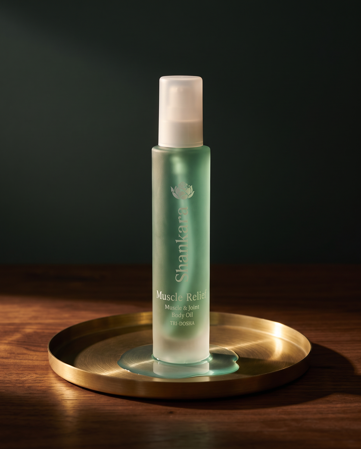 Shankara Muscle Relief Oil 100ml bottle on a brass tray
